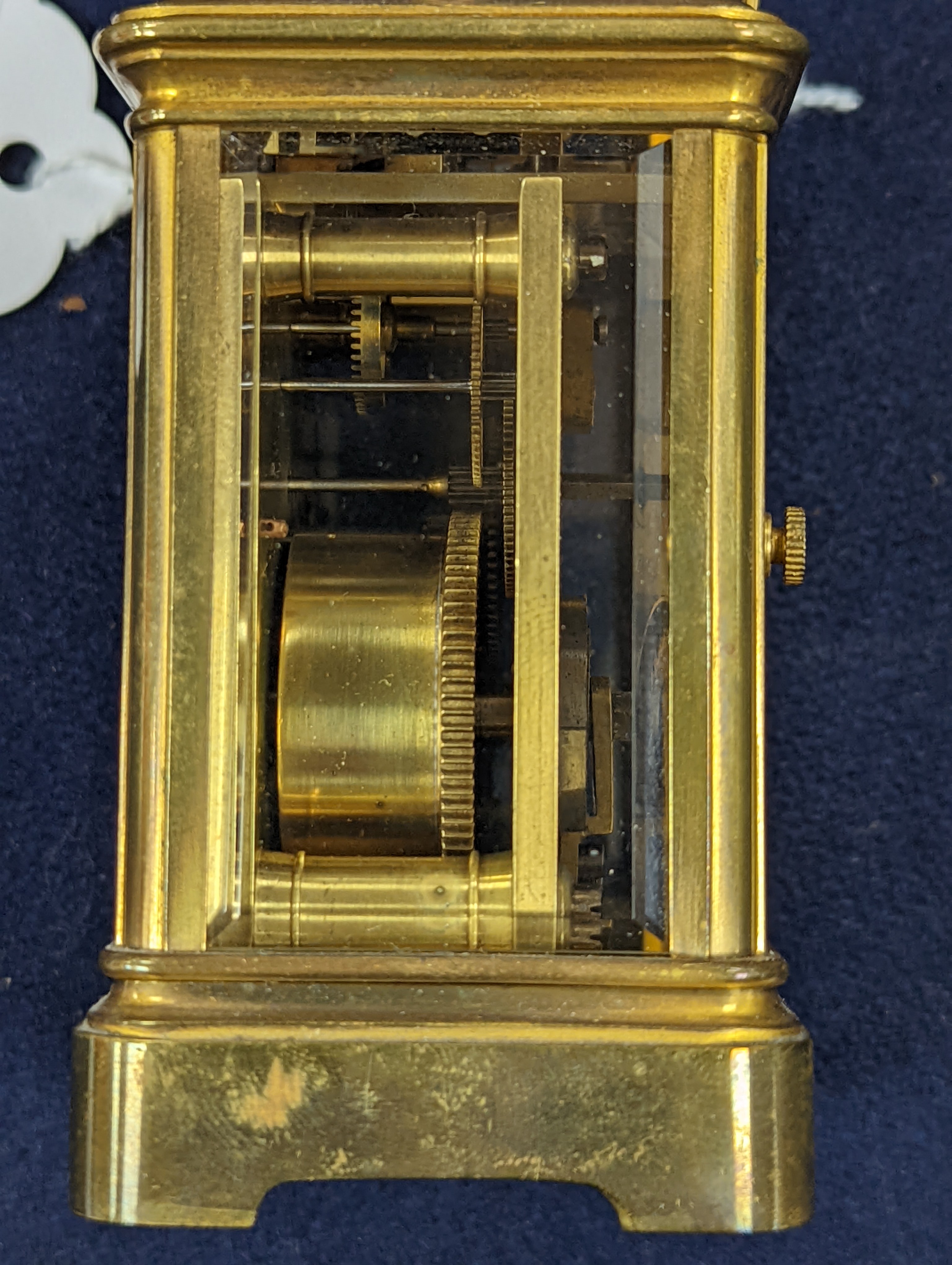 A Henri Jacot brass miniature carriage timepiece, 9.7 cm high with the handle up, cased